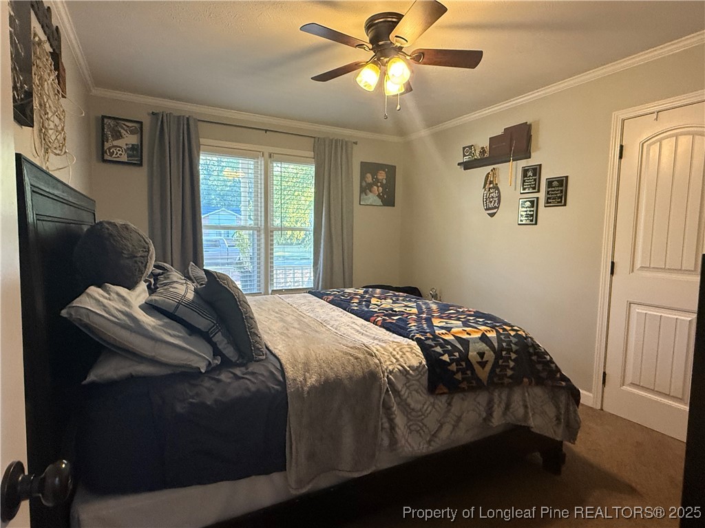 3057 Westminster Road Lumberton, NC 28360 - Photo 21 of 35 a bedroom with a bed and wooden floor