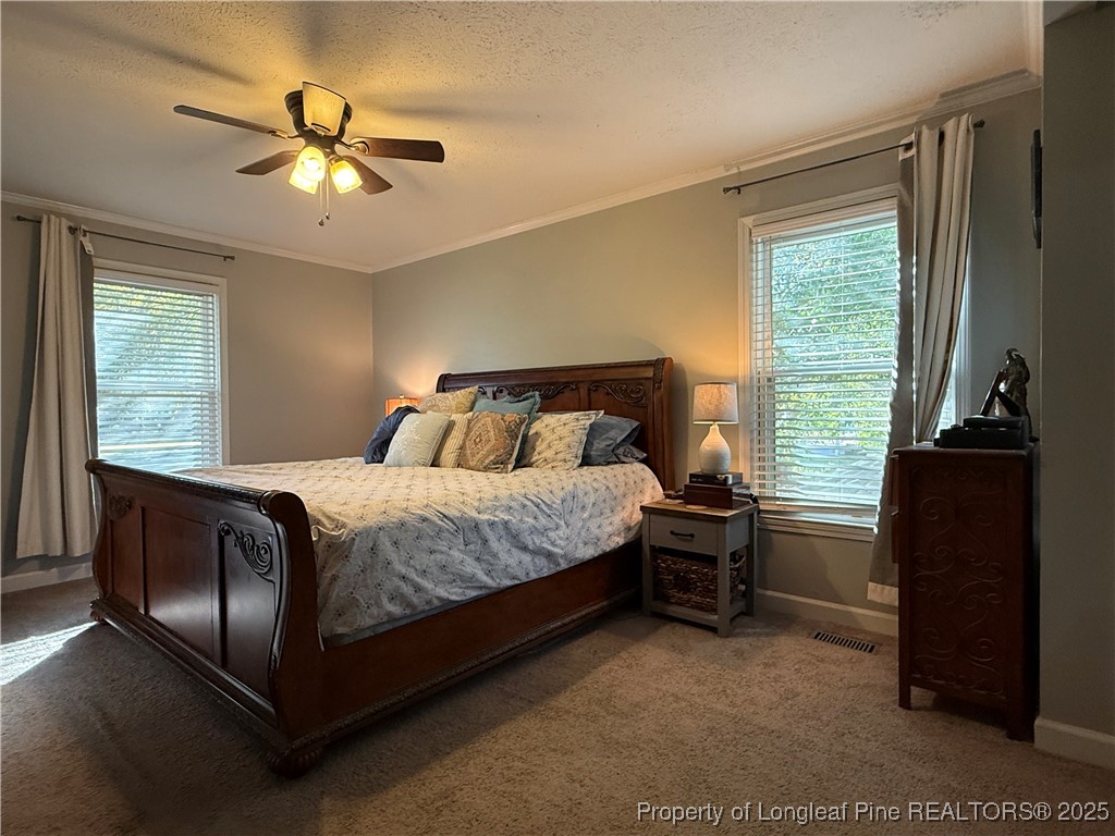 3057 Westminster Road Lumberton, NC 28360 - Photo 24 of 35 a bedroom with a bed and a chandelier