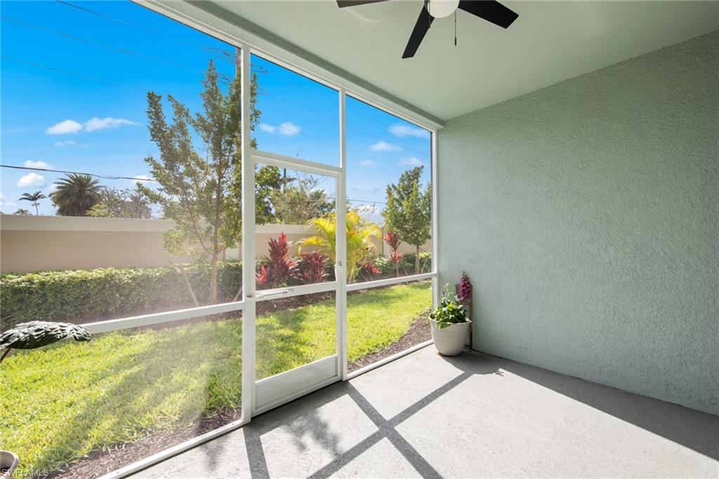 4688 Arboretum Circle, Unit 101 Naples, FL 34112 - Photo 17 of 24 Unfurnished sunroom with ceiling fan