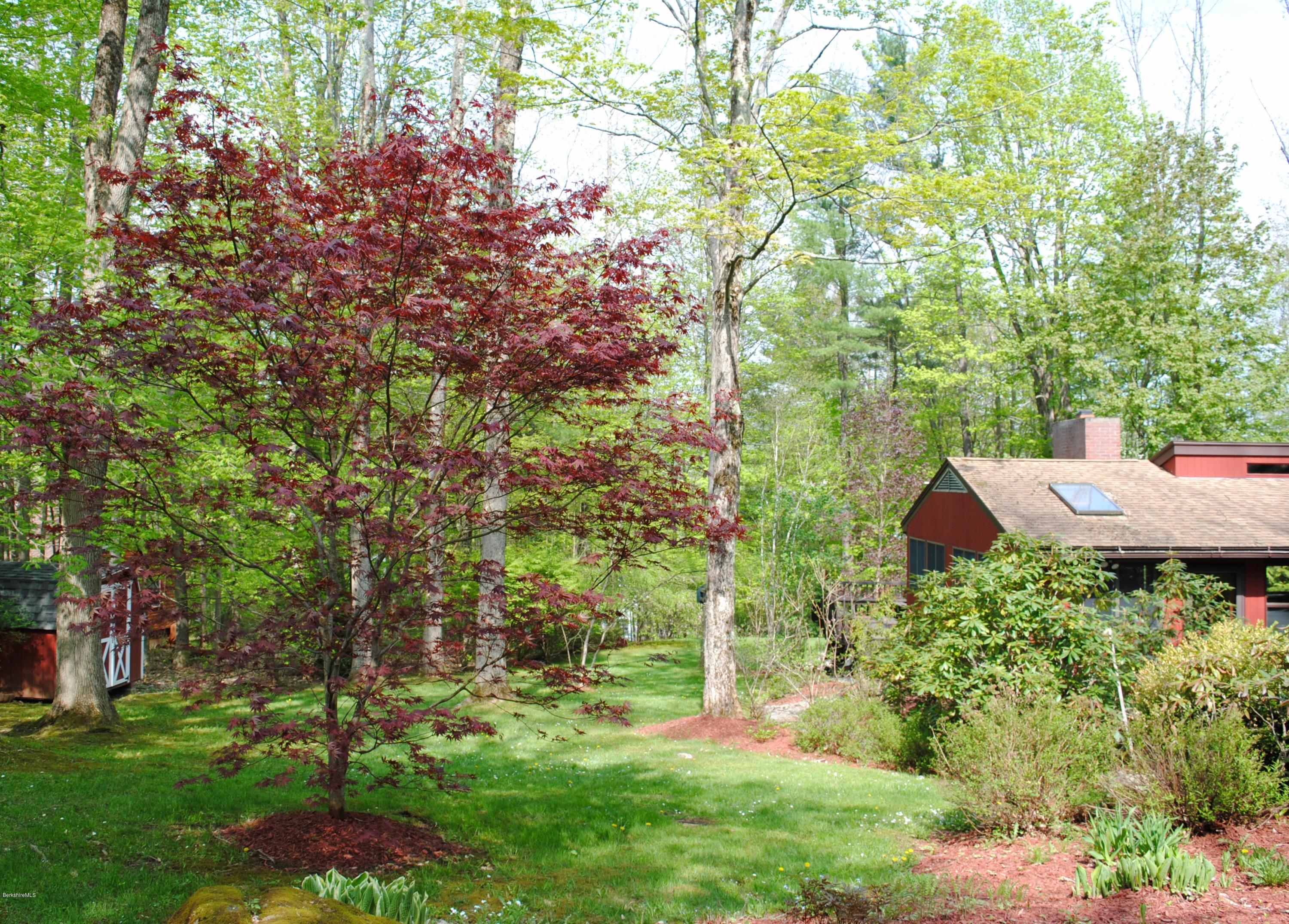 1 Mohigan Road Stockbridge, MA 01262 - Photo 2 of 15 a backyard of a house with outdoor seating and green space