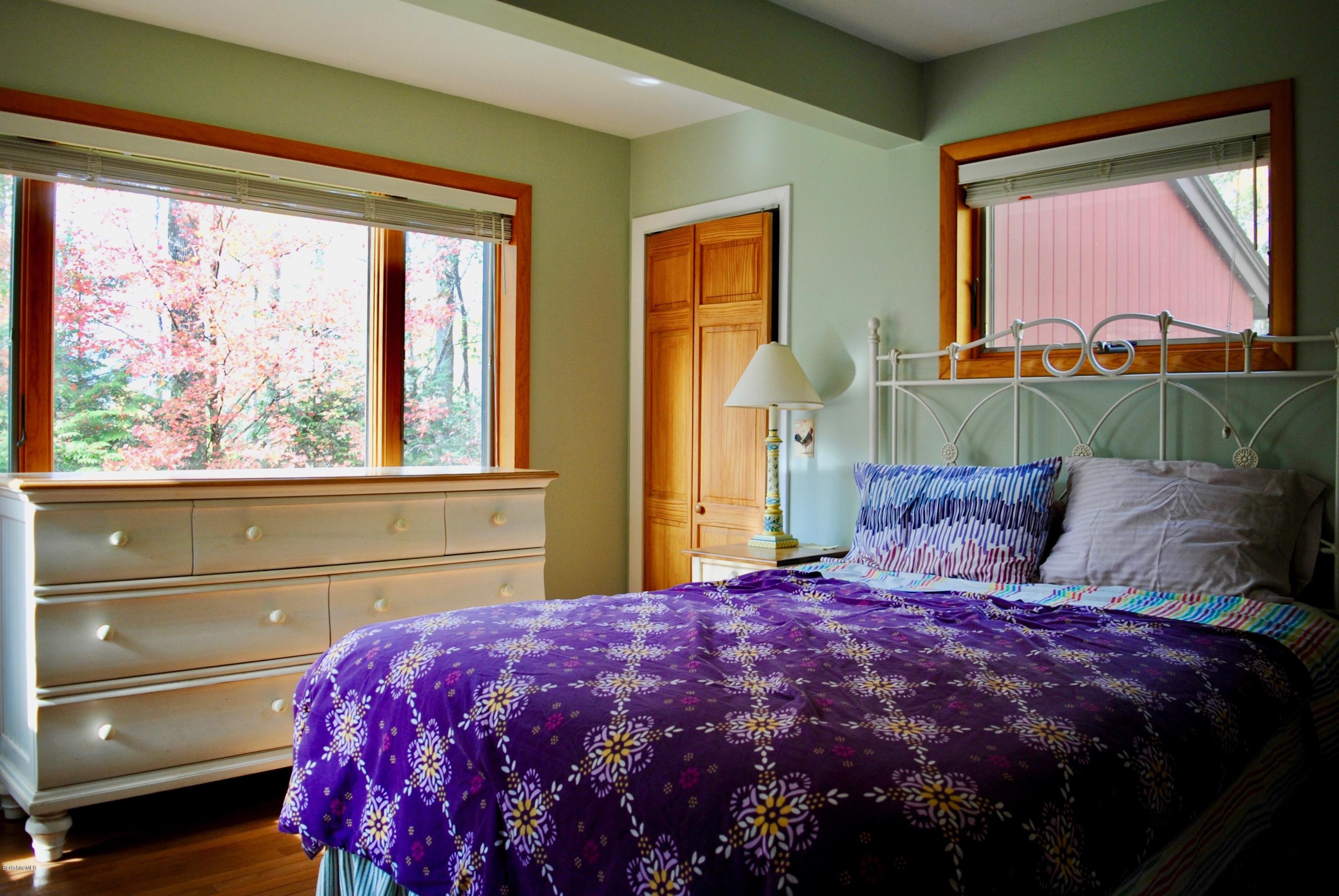 1 Mohigan Road Stockbridge, MA 01262 - Photo 11 of 15 a large bed sitting in a bedroom next to a window
