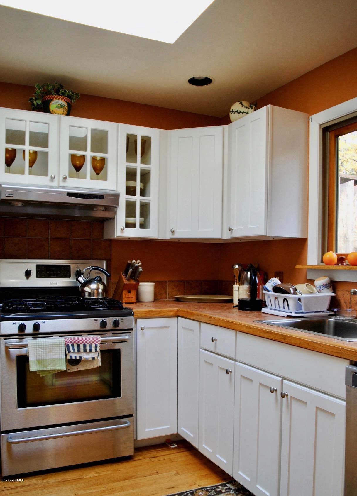 1 Mohigan Road Stockbridge, MA 01262 - Photo 9 of 15 a kitchen with stainless steel appliances a stove a sink and cabinets