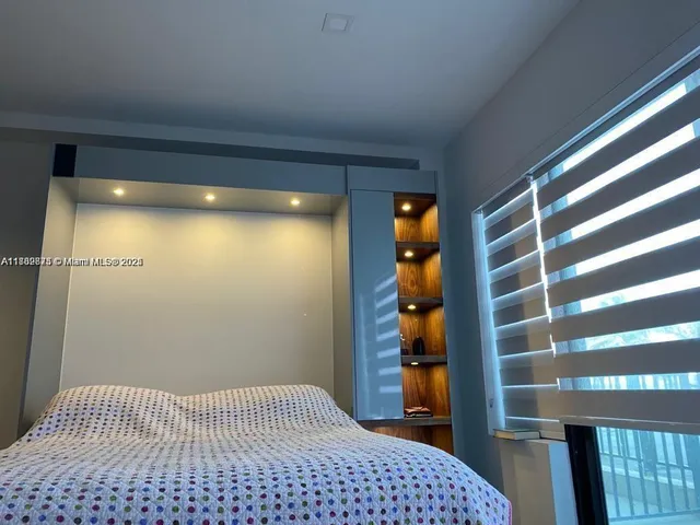 a bedroom with a bed and a walk in closet
