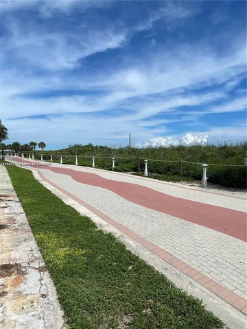 a view of a pathway both side of building with yard
