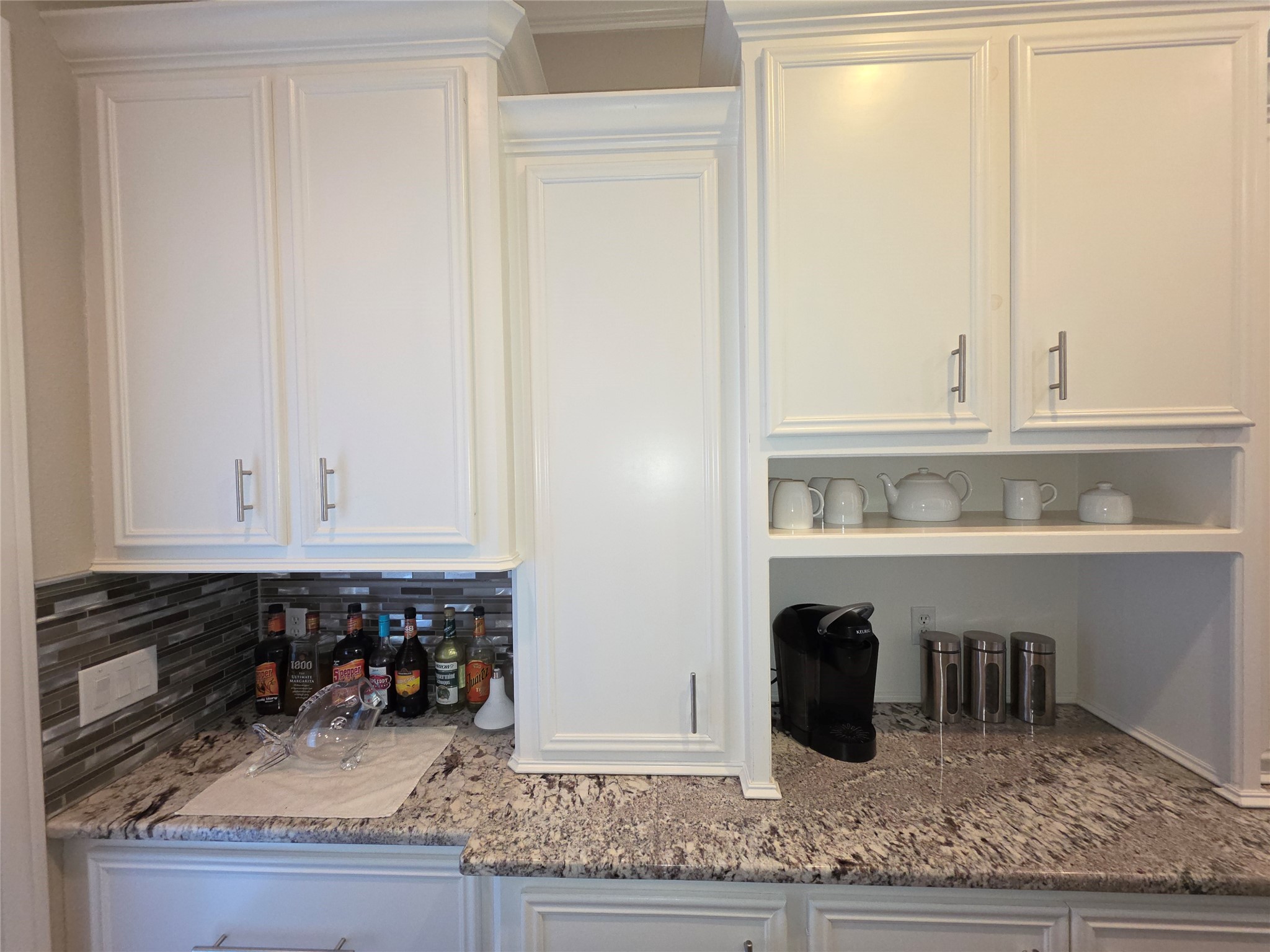 201 Coco Loop Point Blank, TX 77364 - Photo 11 of 50 a kitchen with a granite countertop sink and white cabinets