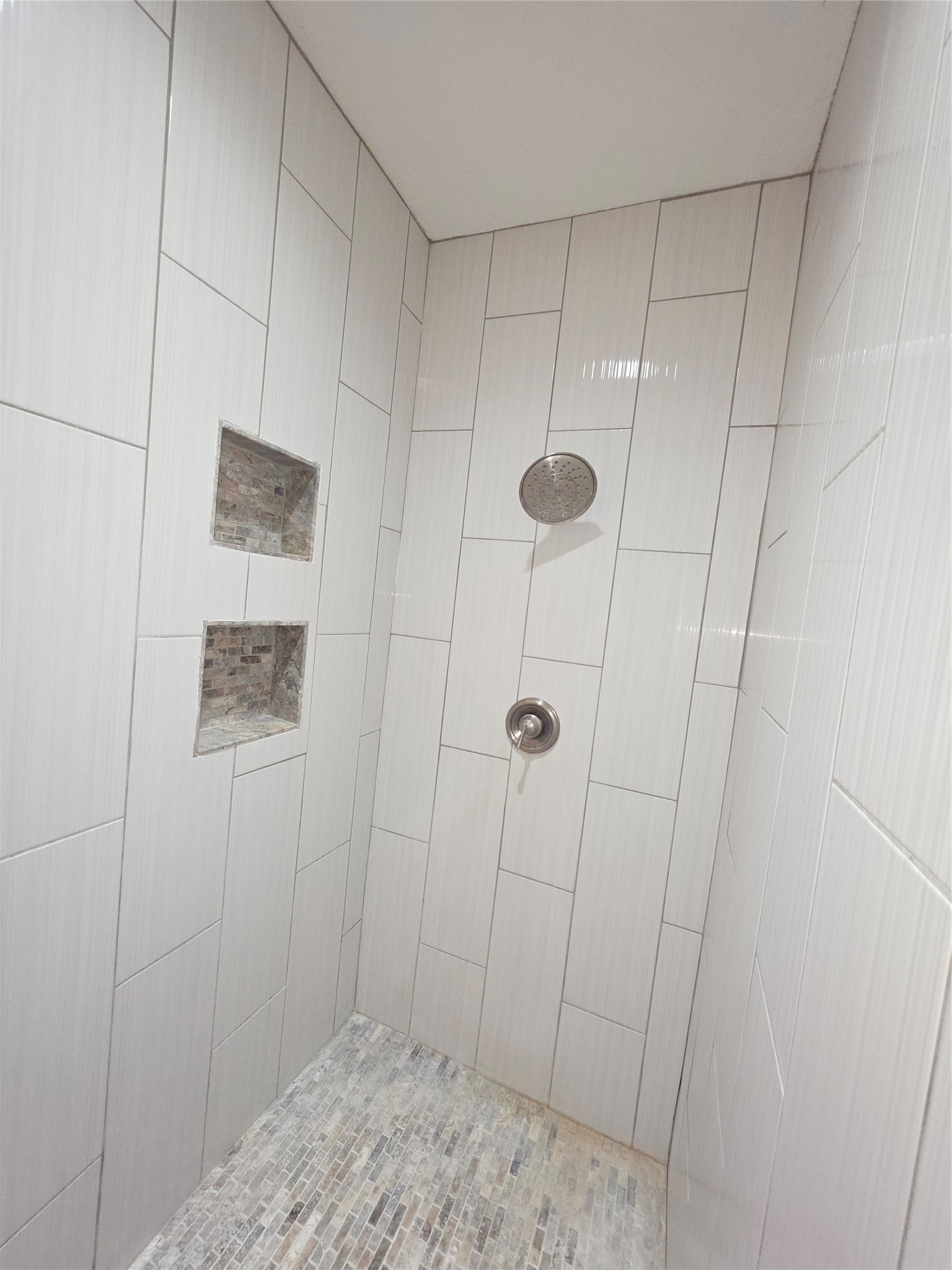201 Coco Loop Point Blank, TX 77364 - Photo 34 of 50 Photo features large walk-in shower with rain shower head, bench seat and 2 cubby holes.