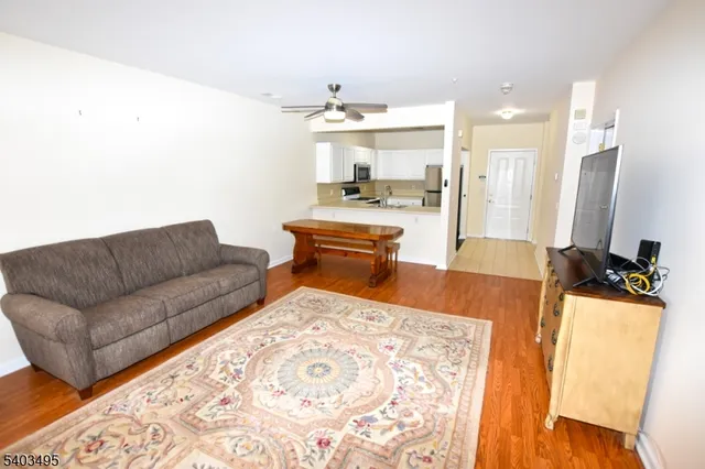 a living room with furniture and a chandelier