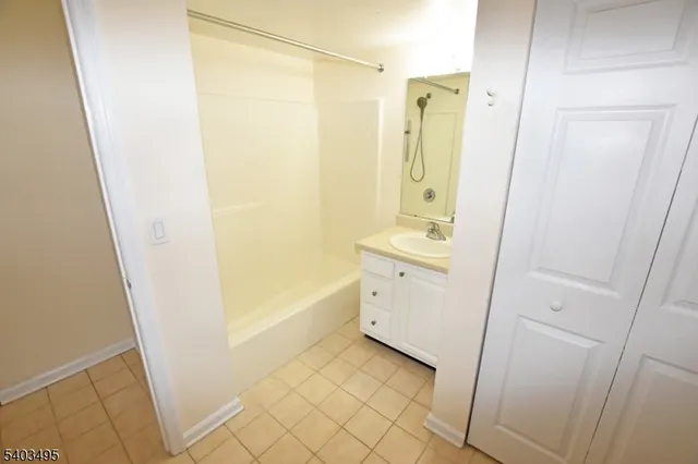 a bathroom with a sink mirror and a bathtub