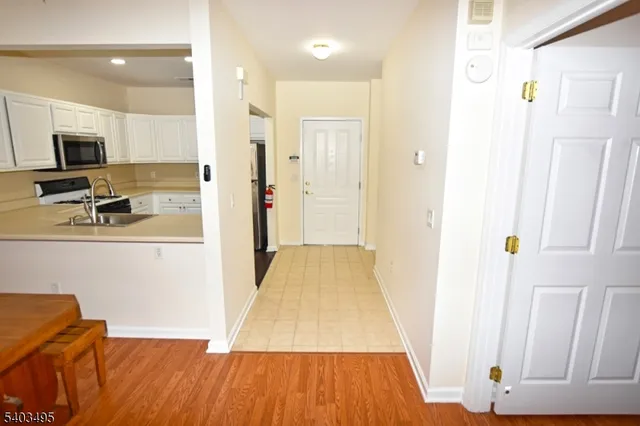 a view of a room with wooden floor and furniture
