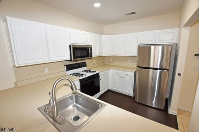 a kitchen with a refrigerator sink and microwave