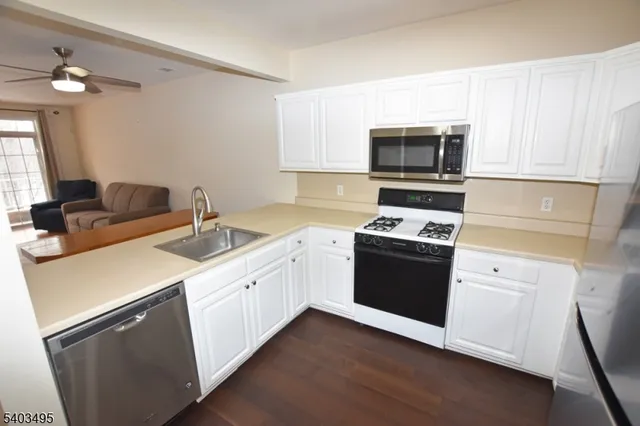 a kitchen with a sink stove and microwave