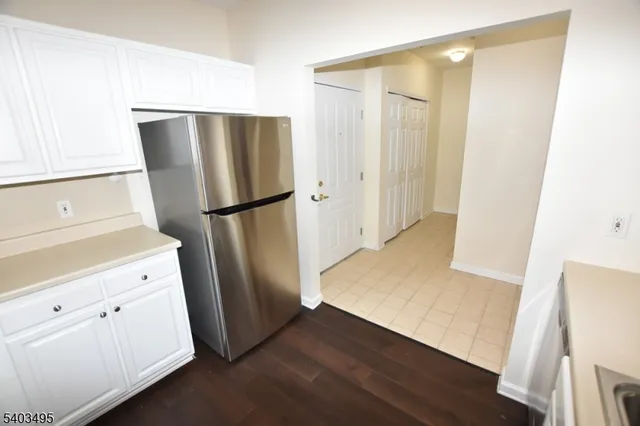 a kitchen with a refrigerator a sink