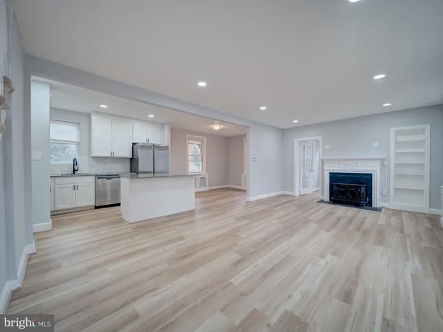a view of kitchen with wooden floor and a window