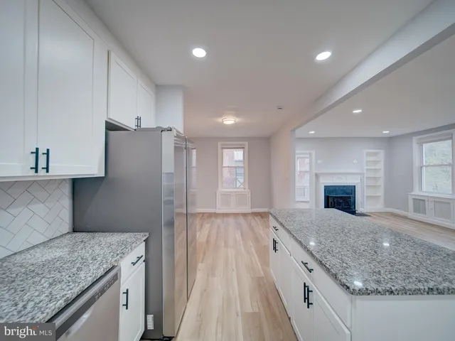 a kitchen with a sink stove and refrigerator