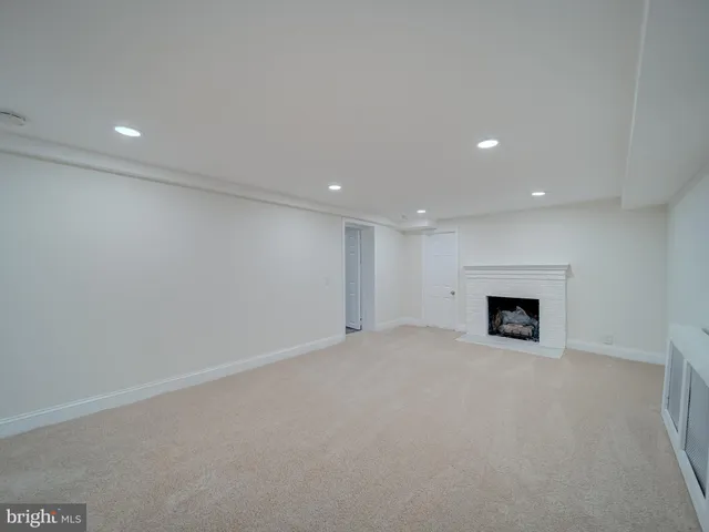 a view of an empty room with a fireplace