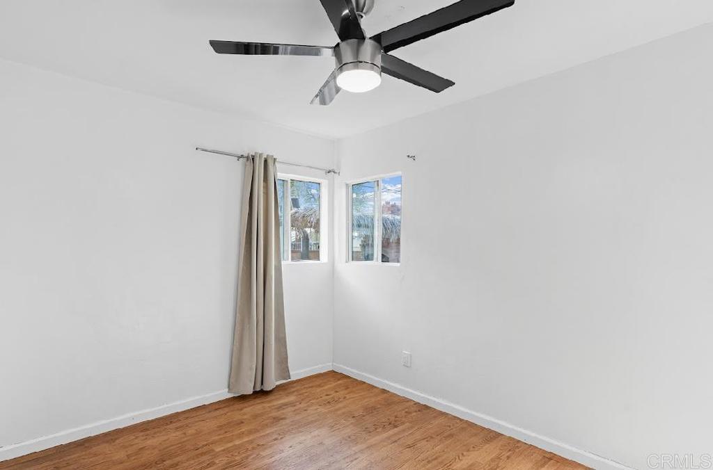 3964 Delta Street San Diego, CA 92113 - Photo 13 of 35 an empty room with a window and ceiling fan
