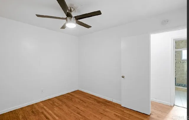 a view of a room with wooden floor