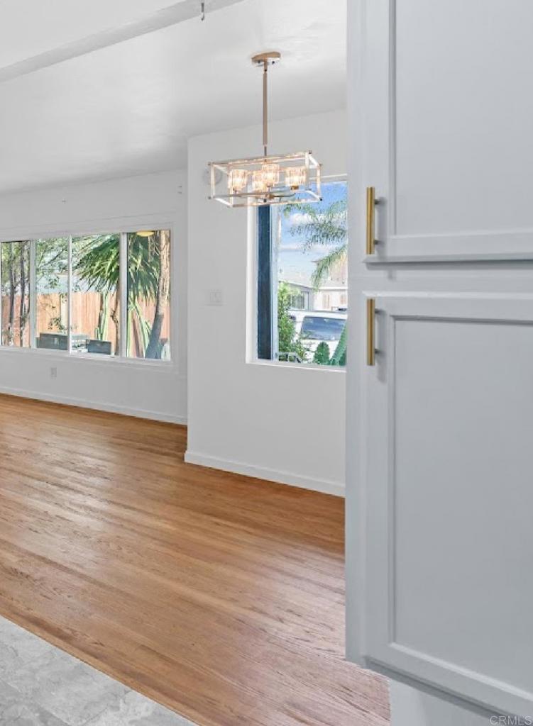 3964 Delta Street San Diego, CA 92113 - Photo 18 of 35 a view of an empty room with wooden floor and a window