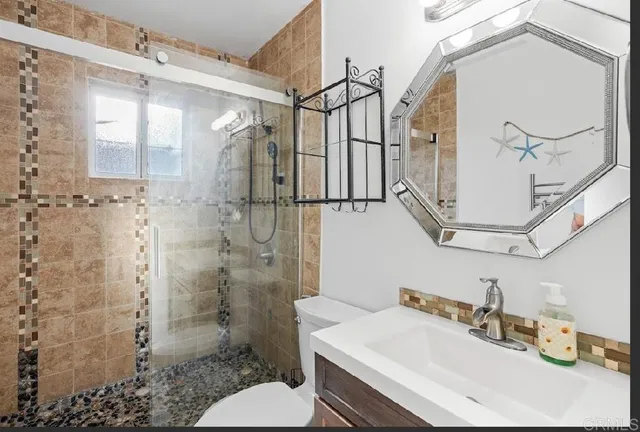 a bathroom with a sink toilet and shower
