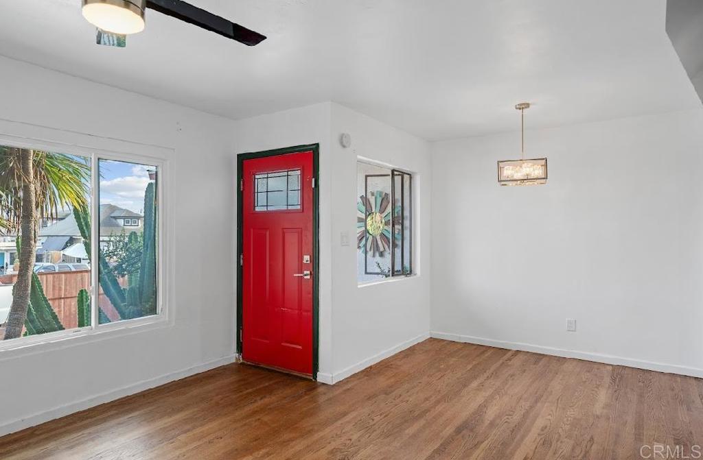 3964 Delta Street San Diego, CA 92113 - Photo 6 of 35 a view of an empty room with window and wooden floor