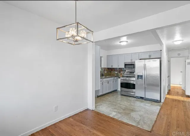 a kitchen with stainless steel appliances a refrigerator and a sink
