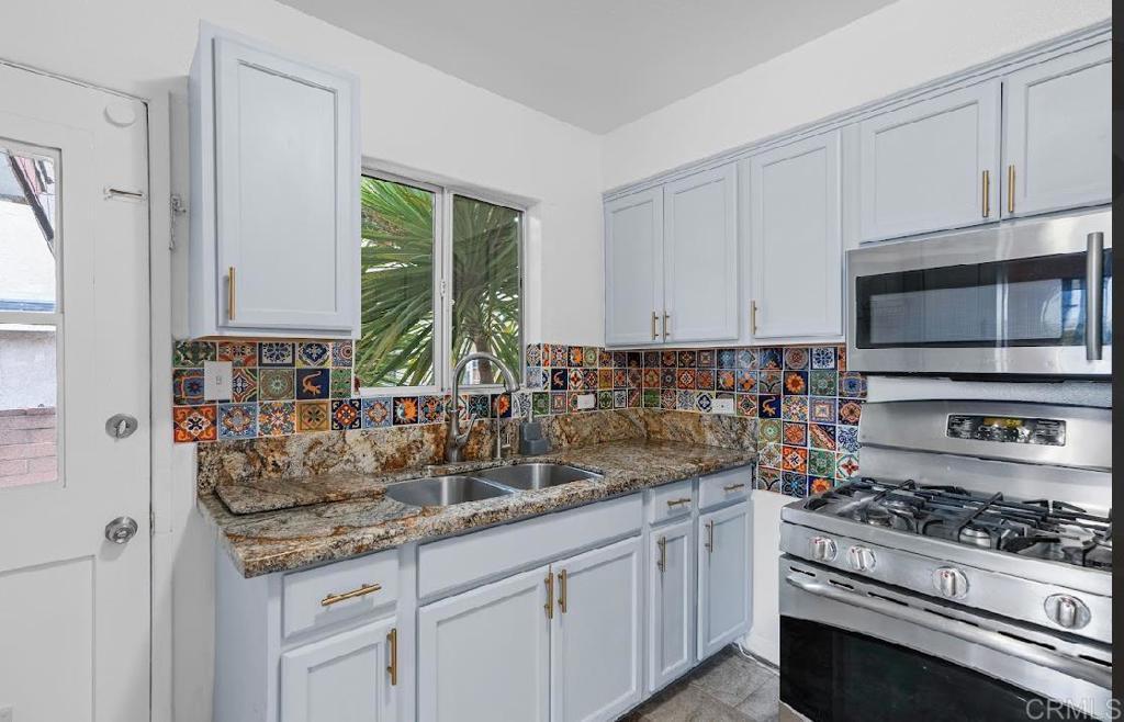 3964 Delta Street San Diego, CA 92113 - Photo 10 of 35 a kitchen with stainless steel appliances granite countertop a sink stove and cabinets
