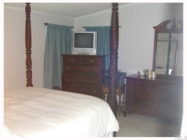 204 Irelan Drive Raleigh, NC 27606 - Photo 11 of 12 a bedroom with a bed and a flat screen tv