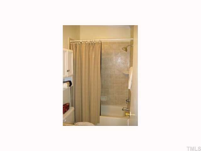 204 Irelan Drive Raleigh, NC 27606 - Photo 6 of 12 a bathroom with a shower and a mirror