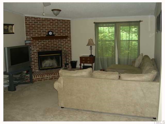 204 Irelan Drive Raleigh, NC 27606 - Photo 8 of 12 a living room with furniture and a fireplace