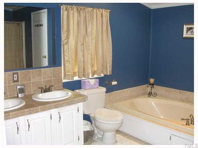 204 Irelan Drive Raleigh, NC 27606 - Photo 10 of 12 a bathroom with a sink and a mirror