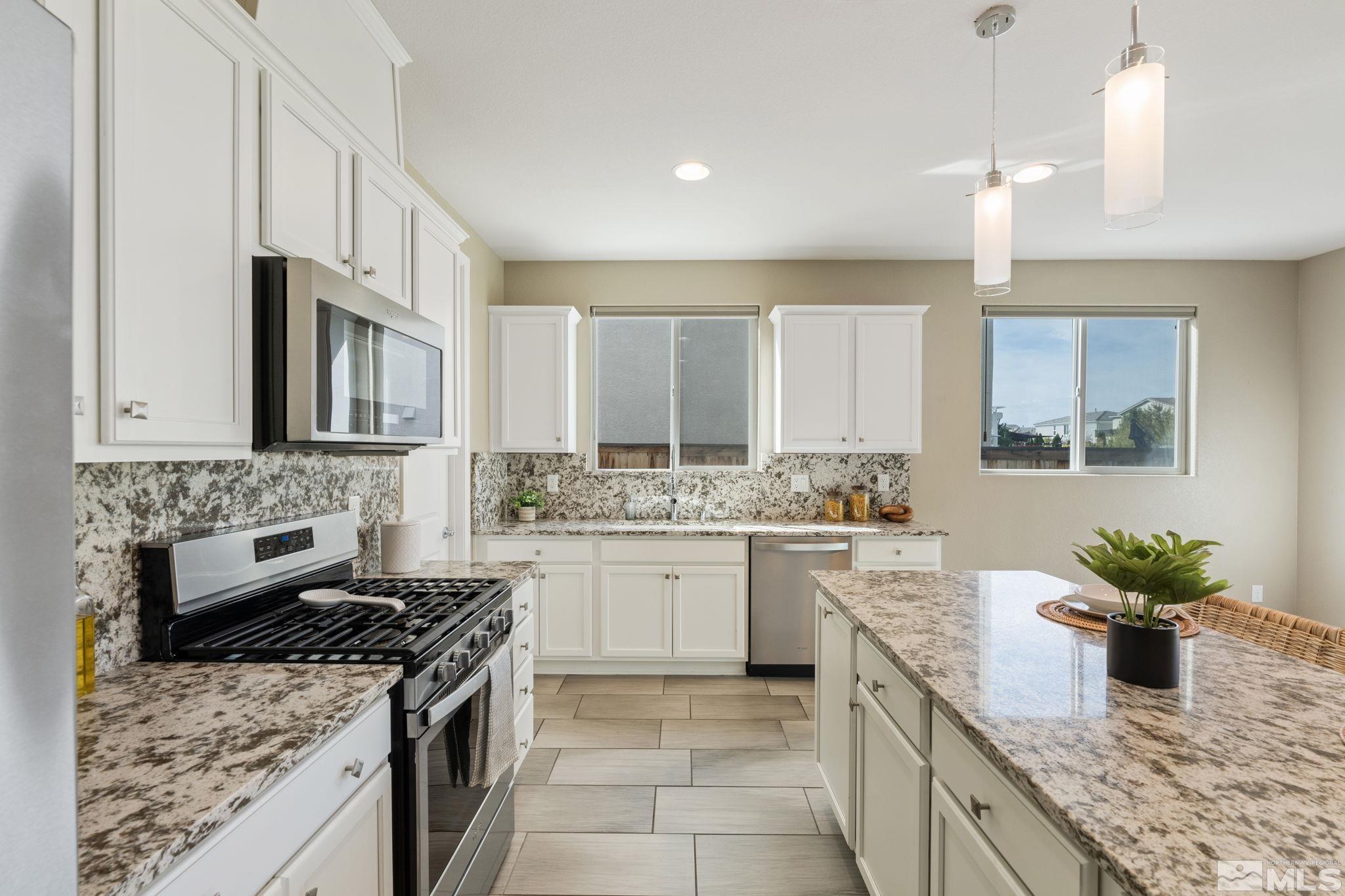 3025 Ethelinda Way Reno, NV 89521 - Photo 11 of 31 a kitchen with a stove top oven sink and cabinets