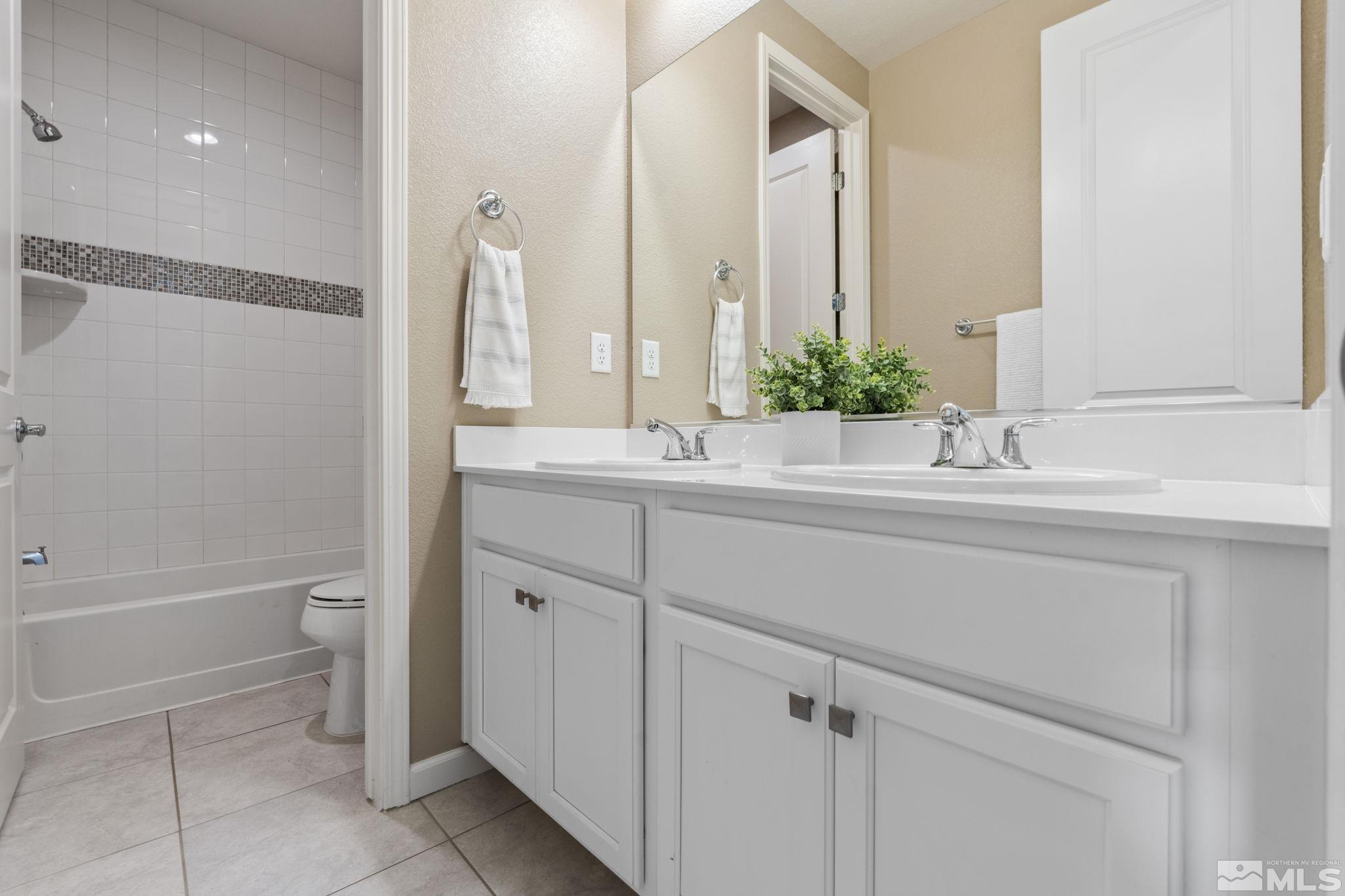 3025 Ethelinda Way Reno, NV 89521 - Photo 21 of 31 a bathroom with a sink a toilet and shower