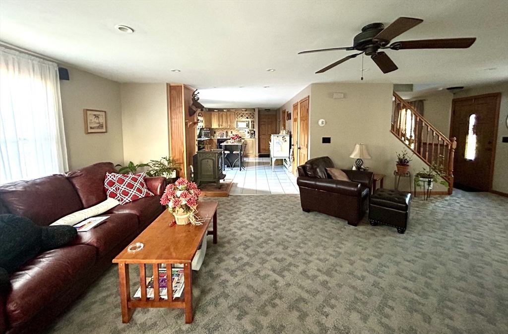 43 Boston Hill Road Fairhaven, MA 02719 - Photo 11 of 25 a living room with furniture a ceiling fan and a rug