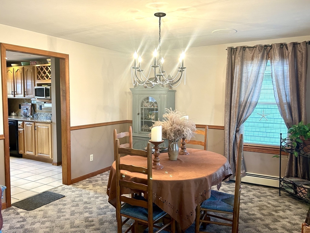 43 Boston Hill Road Fairhaven, MA 02719 - Photo 17 of 25 a dining room with furniture a chandelier and wooden floor