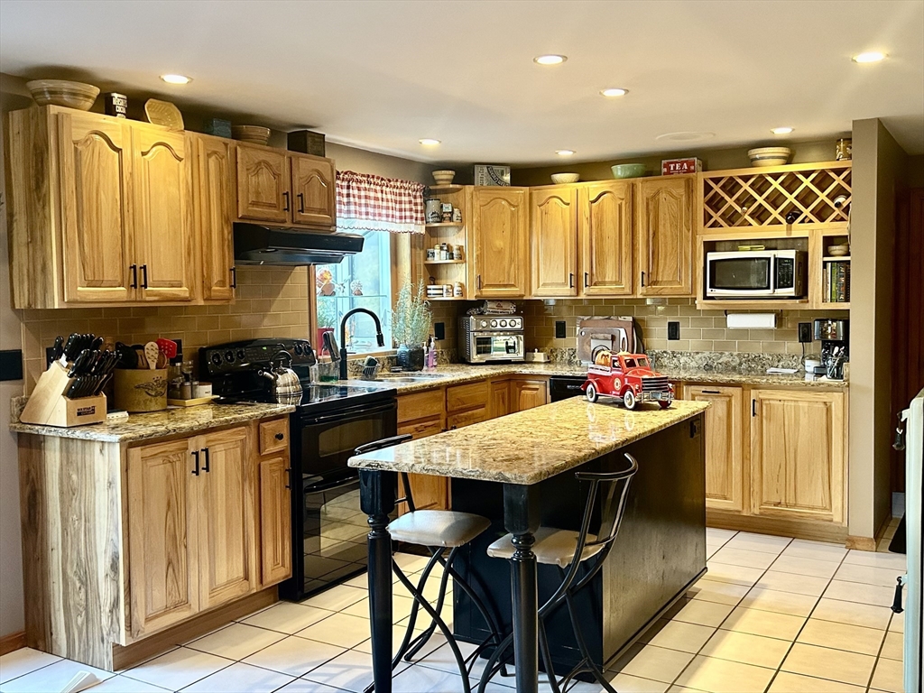 43 Boston Hill Road Fairhaven, MA 02719 - Photo 8 of 25 a kitchen with kitchen island granite countertop a sink and counter space