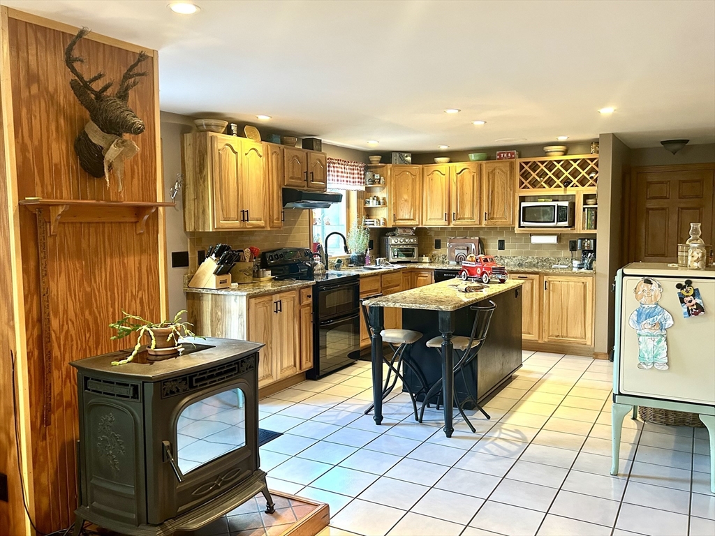 43 Boston Hill Road Fairhaven, MA 02719 - Photo 10 of 25 a room with stainless steel appliances kitchen island granite countertop a sink and cabinets
