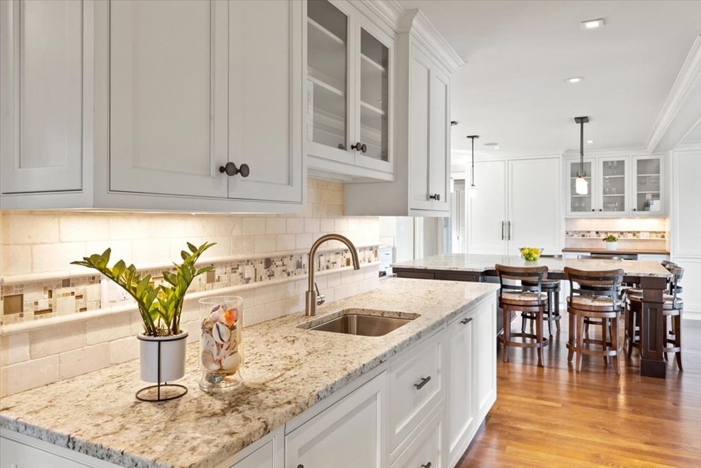 15 Spray Avenue Marblehead, MA 01945 - Photo 11 of 42 a kitchen with kitchen island granite countertop a sink a stove and cabinets