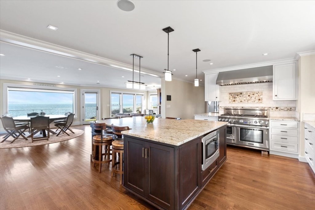 15 Spray Avenue Marblehead, MA 01945 - Photo 7 of 42 a kitchen with stainless steel appliances granite countertop a stove and chairs