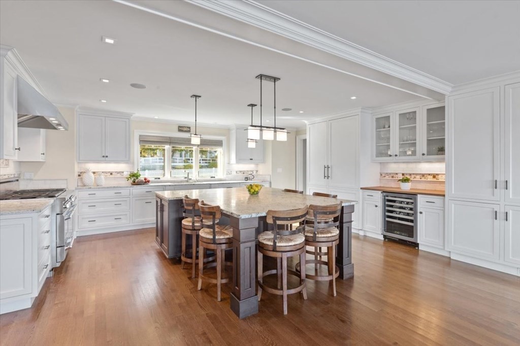 15 Spray Avenue Marblehead, MA 01945 - Photo 8 of 42 a kitchen with stainless steel appliances kitchen island wooden floors chairs and white counter top space