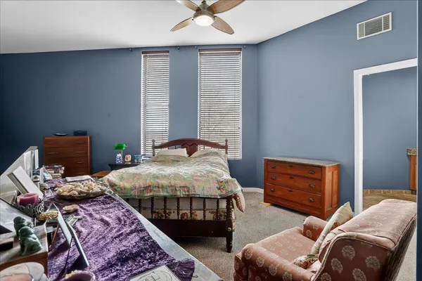 a bedroom with bed and a window