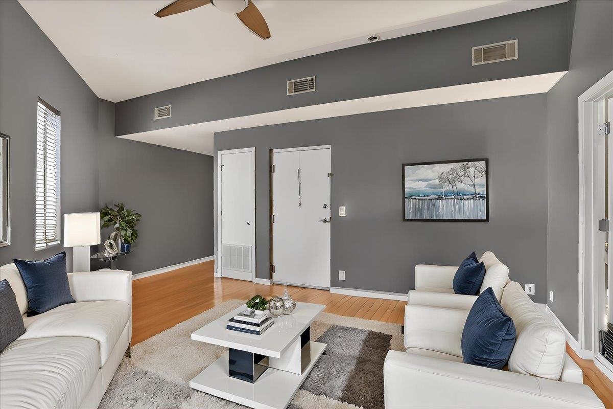 440 North Front Street, Unit 202 Memphis, TN 38105 - Photo 5 of 20 a living room with furniture and a wooden floor