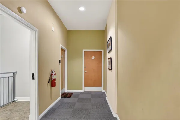 a view of a hallway with wooden shelves