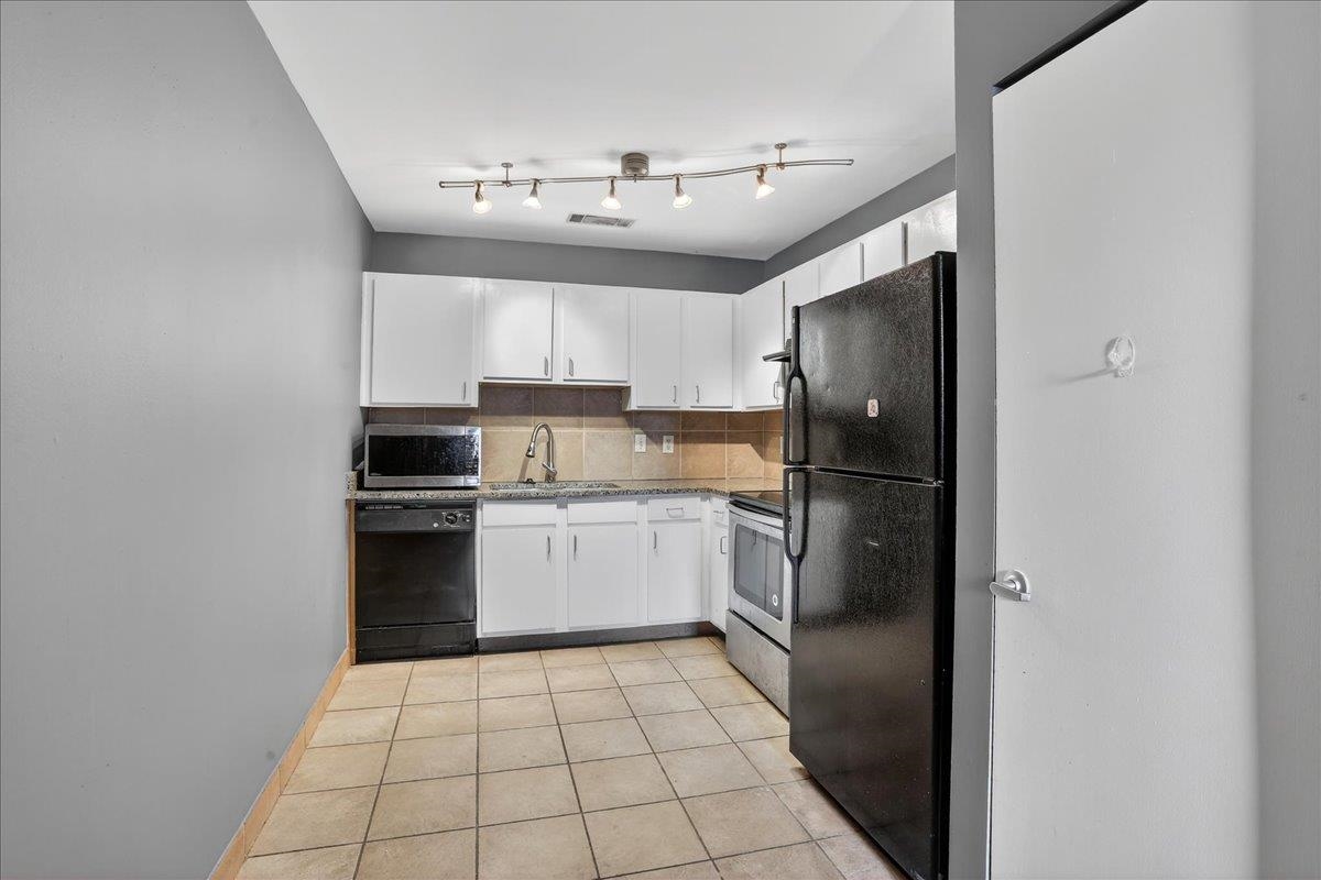 440 North Front Street, Unit 202 Memphis, TN 38105 - Photo 7 of 20 a kitchen with a refrigerator a sink dishwasher and a stove top oven