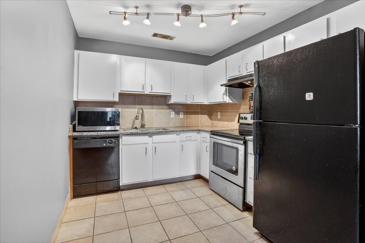 440 North Front Street, Unit 202 Memphis, TN 38105 - Photo 8 of 20 a kitchen with a refrigerator and a stove top oven