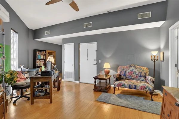 a living room with furniture and wooden floor