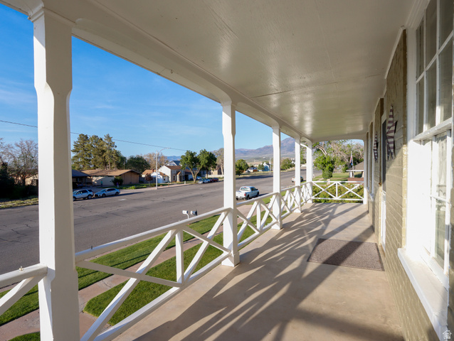 155 West Center Street Fillmore, UT 84631 - Photo 53 of 86 Spacious covered front porch featuring white pillars and a decorative railing