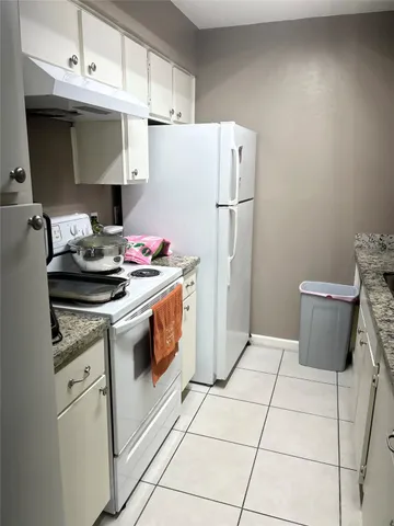 a kitchen with a stove and a refrigerator