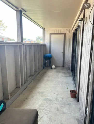 a view of an empty room with windows