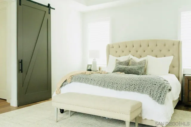 a spacious bedroom with a bed and a window