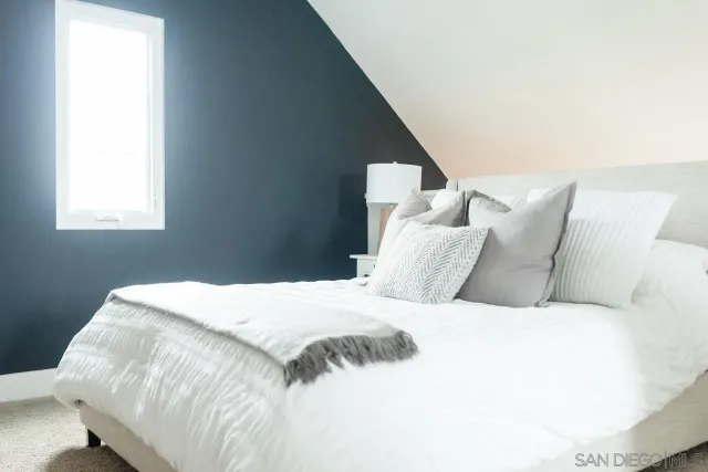 a large white bed in a small room